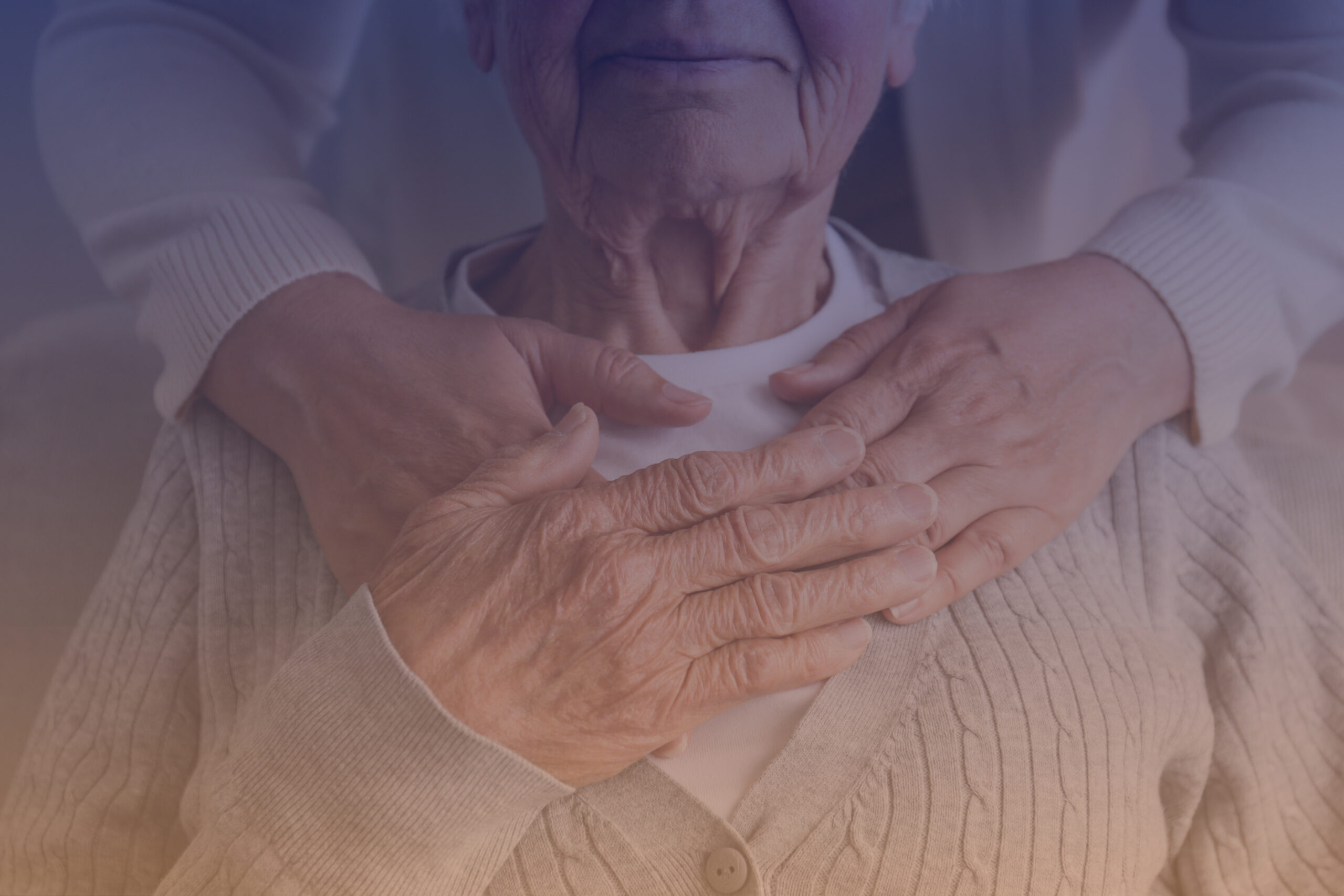 Unrecognizable female expressing care towards an elderly lady, hugging her from behind holding hands. Two adult women of different age. Family values concept. lose up, copy space, background.